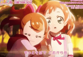 two anime girls are hugging each other in a scene with chinese writing on the bottom