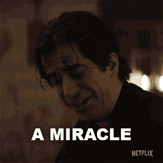 a man with blood on his face is smiling with the words a miracle below him