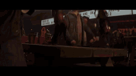 a close up of a person in a superhero costume fighting another person .