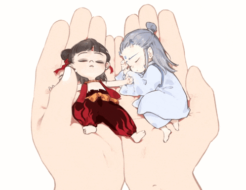 a hand is holding two sleeping children in it