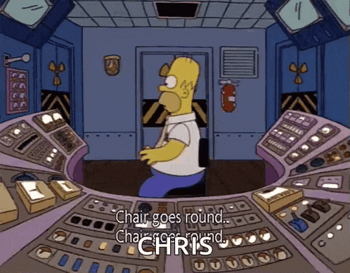 a cartoon of homer simpson sitting at a control panel with the words chair goes round