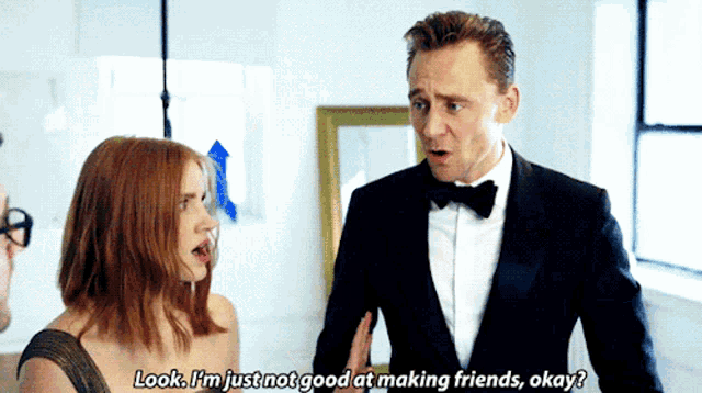 a man in a tuxedo talks to a woman who says look i 'm just not good