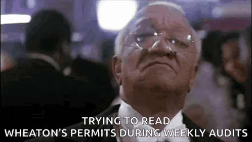 an older man in a tuxedo and bow tie is trying to read wheaton 's permits during weekly audits