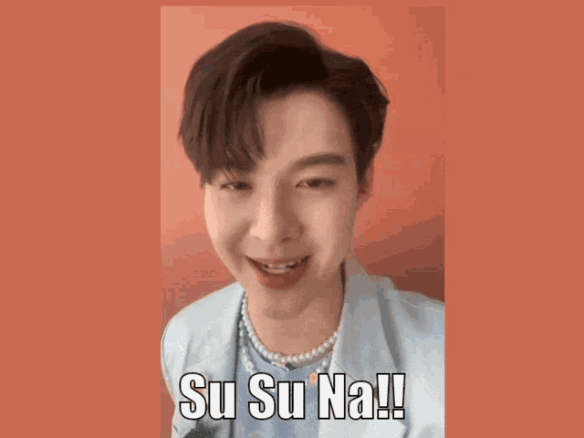 a man wearing a pearl necklace says su su na !!!