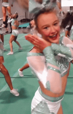 a cheerleader wearing a blue and white outfit with the word cheer on the front