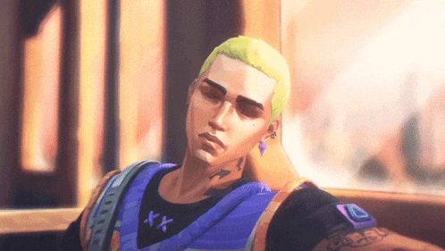 a man with a tattoo on his arm is wearing a purple shirt with the letter x on it