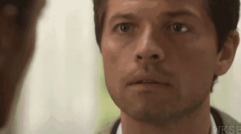 a close up of a man 's face looking at another man
