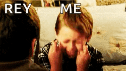 a young boy is sitting on a couch with his hands on his face and the words `` rey me '' written above him .