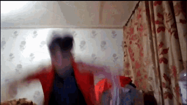 a blurry picture of a person in a red jacket