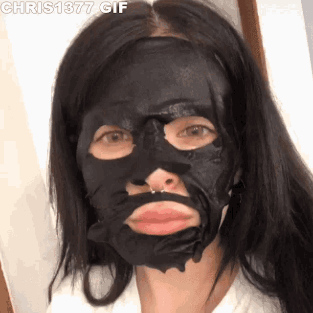 a woman with a black mask on her face and the words chris1377 gif below her
