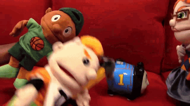 a puppet with the number 1 on it is being held by another puppet