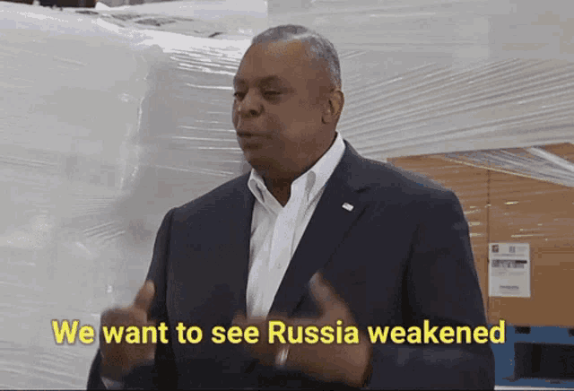 a man in a suit and white shirt says " we want to see russia weakened "
