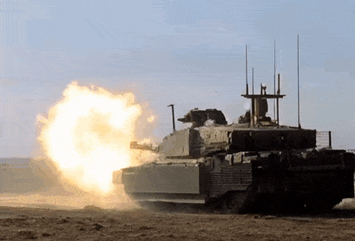 a military tank is firing a rocket in a field