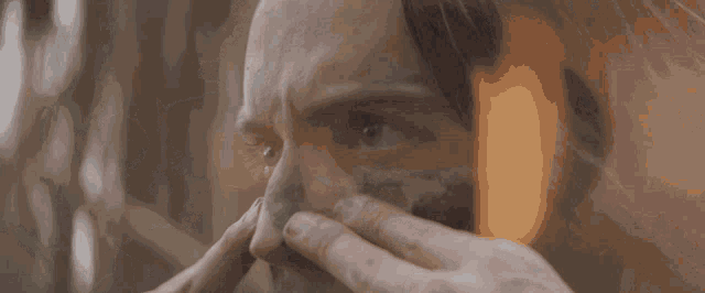 a close up of a person cleaning their face