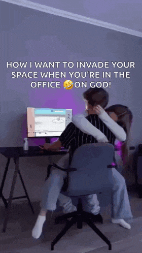 a man and a woman are sitting in front of a computer .