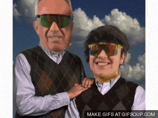 an older man and a younger man wearing sunglasses are standing next to each other