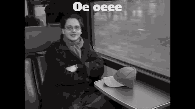 a black and white photo of a woman on a train with oe oeee written above her