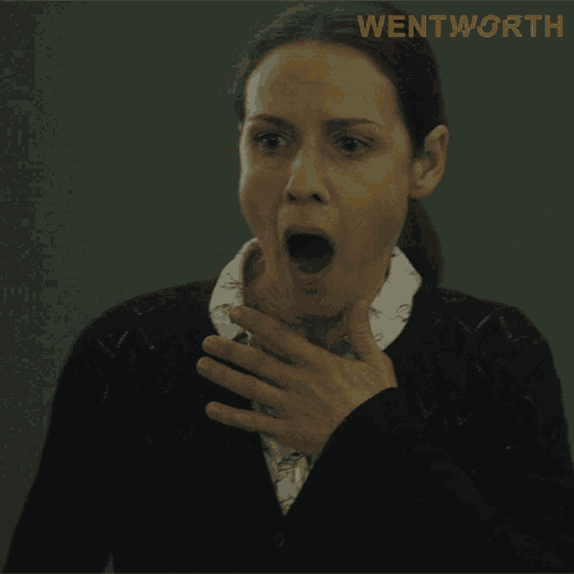 a woman with a surprised look on her face and the word wentworth on the bottom right