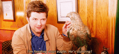 a man is holding a statue of an eagle in his hand .