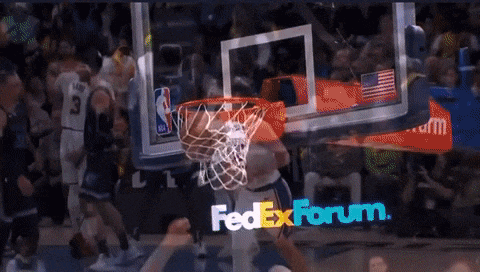 a basketball game is being played in front of a fedex forum banner