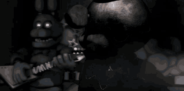a teddy bear playing a guitar next to another teddy bear in a dark room