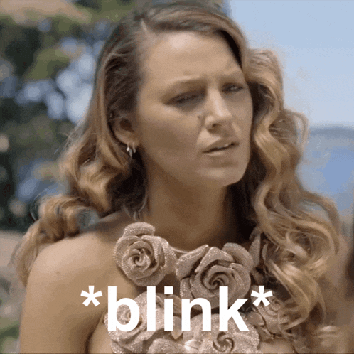 a woman with a necklace of roses and the words * blink * on the bottom