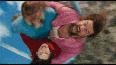a man in a pink shirt is holding a woman in a pink shirt