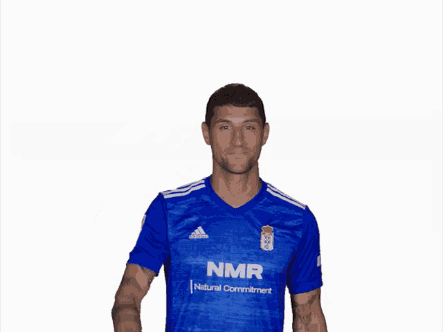 a man wearing a blue shirt with nmr on it