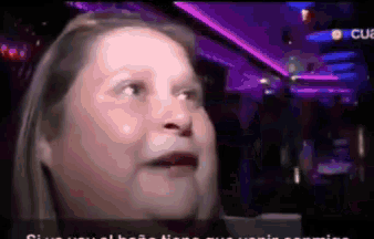 a pixelated image of a woman in a dark room with purple lights behind her