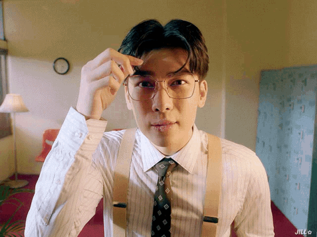 a man wearing suspenders and glasses has the word jill on the bottom