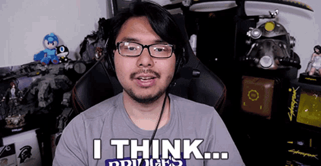 a man wearing glasses and headphones says " i think "