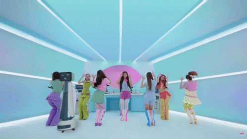 a group of girls are dancing in front of a robot