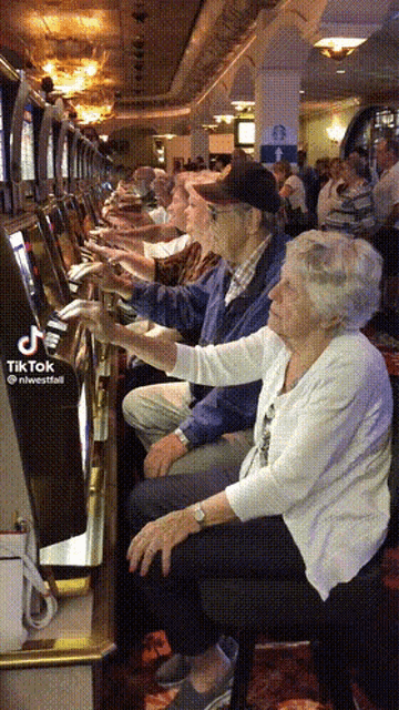 a group of elderly people playing a slot machine with a tik tok watermark
