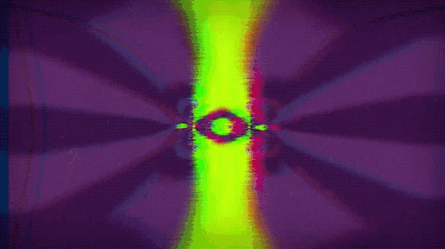 a purple and green background with a cartoon face in the middle