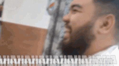 a blurry picture of a man with a beard and a few lines on the bottom of the image