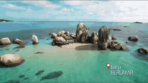 batu berlayar is written on the bottom of a picture of a beach