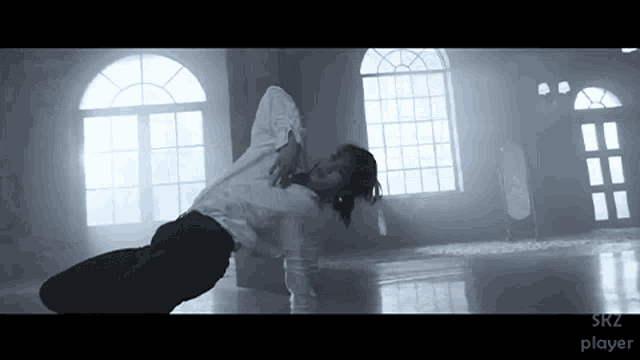 a black and white photo of a man dancing with the words srz player visible