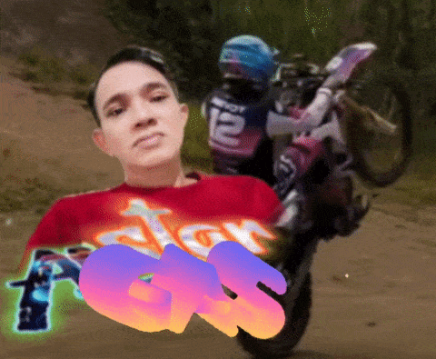 a man in a red shirt with the number 12 on his shirt is riding a dirt bike