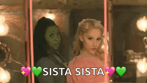 two women are standing next to each other on a swing with the words `` sista sista '' written on it .