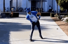 a man in a superhero costume is dancing on a sidewalk