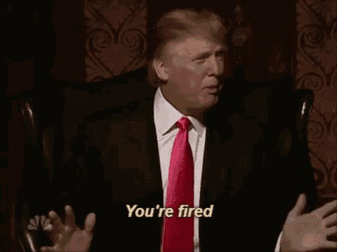 donald trump is sitting in a chair wearing a suit and tie and talking to someone .