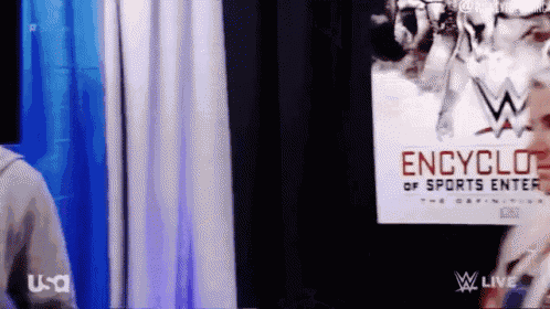 a man standing in front of a sign that says encyclo of sports enter