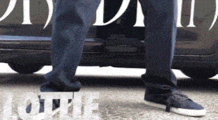 a person is standing in front of a car that says ii on it