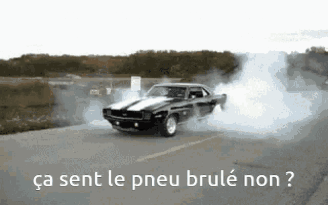 a car is driving down a road with smoke coming out of it and the words ca sent le pneu brule non