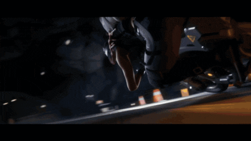 a man is riding a motorcycle down a road at night