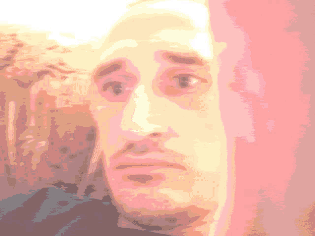 a pixelated image of a man 's face with a surprised expression