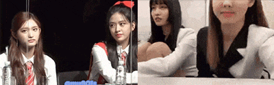 a girl with a red bow in her hair is sitting at a table with other girls