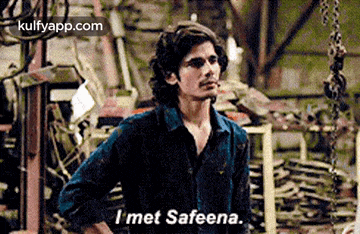 a man in a blue shirt says i met safeena while standing in a factory .