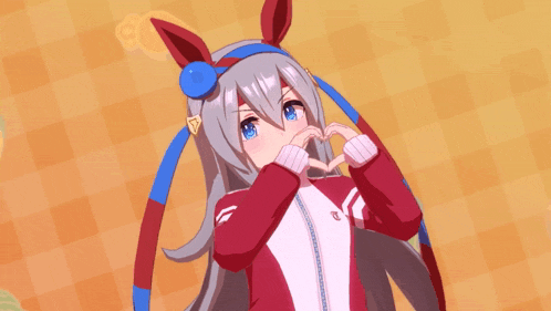 a girl in a red and white jacket making a heart shape with her hands
