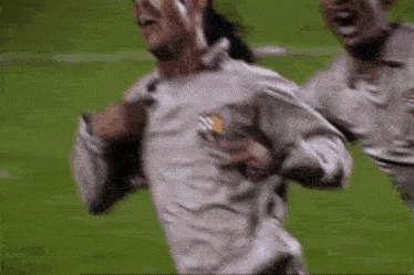 a group of soccer players are running on a field